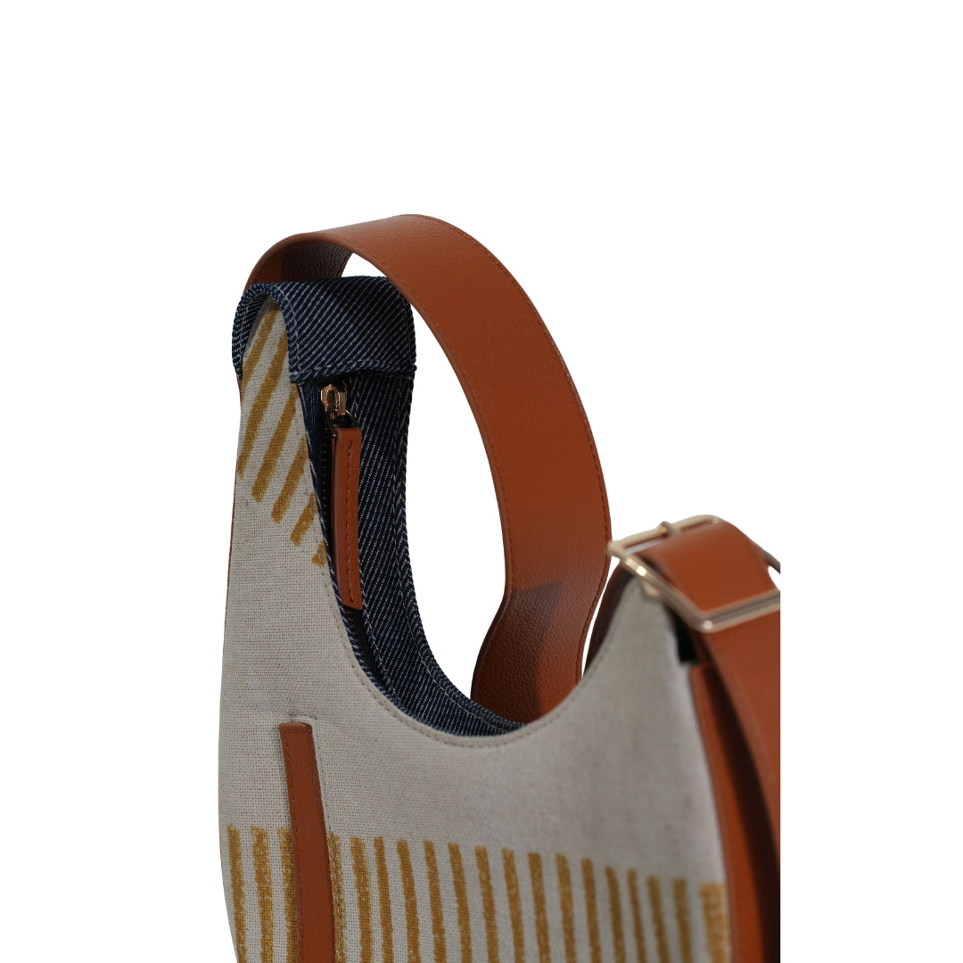 VYAKTI INDIA Dune shoulder bag with beige and brown leather accents, featuring a sleek design and adjustable strap.